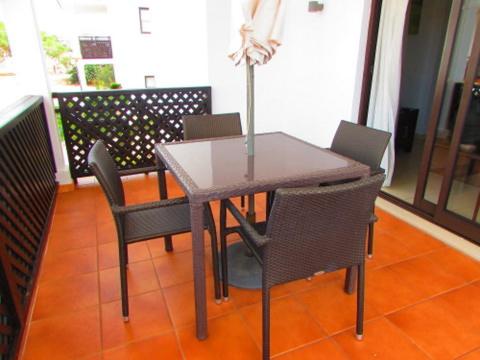 a dining room table with chairs and a vase on it at Tortuga Beach Village Private Apartments and Villas for Rent in Santa Maria