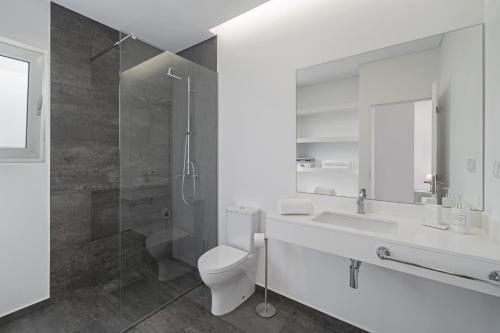 a bathroom with a toilet and a sink and a shower at Villa Calhetascape by Villa Plus in Estreito da Calheta