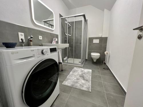 オッフェンバッハにあるApartment Lili-PS5-Terrace-View-Bright-Kitchen-2xBedroomのバスルーム(白い洗濯機、乾燥機付)