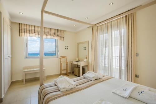 a bedroom with a large bed and a window at Almiriki Chios Rooms & Apartments in Líthion