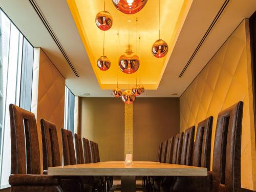 a conference room with a wooden table and chairs at The Royal Park Hotel Iconic Tokyo Shiodome in Tokyo
