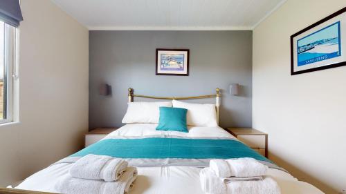 a bedroom with a bed with towels on it at Barker Stakes Farm in Pickering