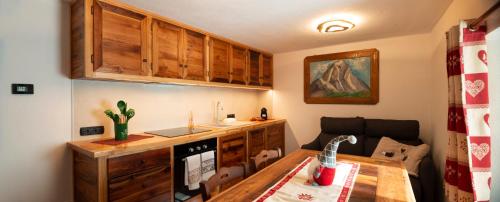 a kitchen with a table and a counter with a stove at C'era una Volta in Valtournenche
