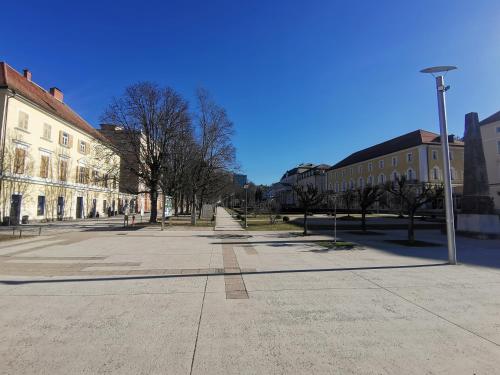 an empty street with buildings and a street light at Apartment Center Rogaška - Pubyland in Rogaška Slatina