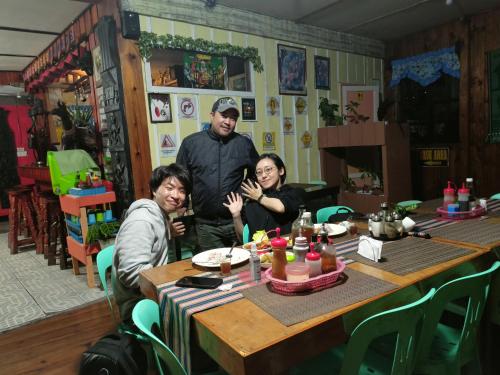 a group of three people sitting at a table at Las vegas lodge and restaurant in Banaue