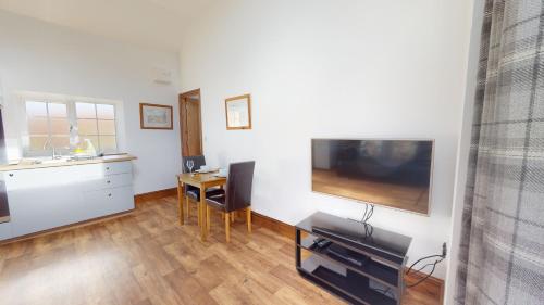 a living room with a large flat screen tv on a wall at Barker Stakes Farm in Pickering