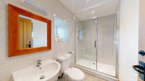 a bathroom with a shower and a toilet and a sink at Barker Stakes Farm in Pickering