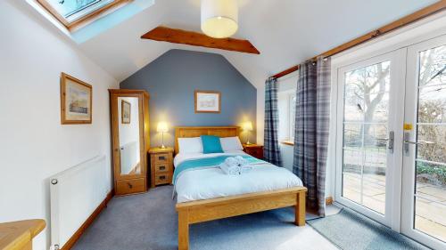 a bedroom with a bed and a window at Barker Stakes Farm in Pickering