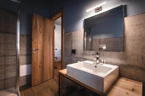 a bathroom with a white sink and a mirror at Locanda Cossetti Ranch Winery in Incisa Scapaccino