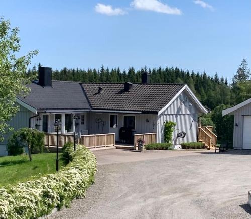 a house with a driveway in front of it at Hybel i underetasje 700m fra strand in Trøgstad