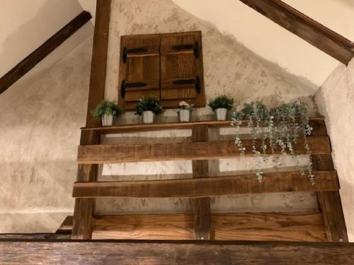 a wooden staircase with potted plants on it at Holiday Home Anka in Gospić