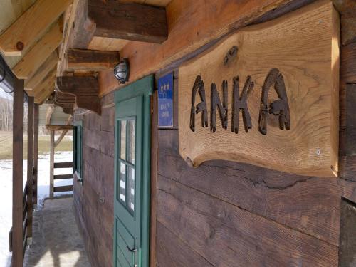 a sign on the side of a wooden building at Holiday Home Anka in Gospić