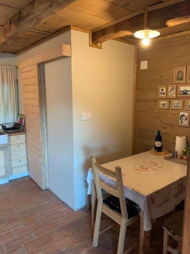 a dining room with a table and a kitchen at Holiday Home Jela in Gospić