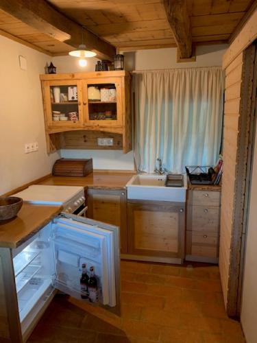 a small kitchen with a sink and a refrigerator at Holiday Home Jela in Gospić