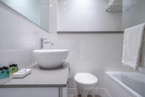 a white bathroom with a sink and a toilet at Modern Villa-Ella Sun Eilat in Eilat