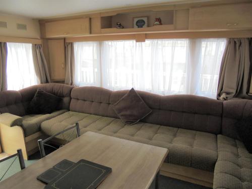 a living room with a couch and a table at 8 Berth on The Chase Ingoldmells Nordstar in Skegness