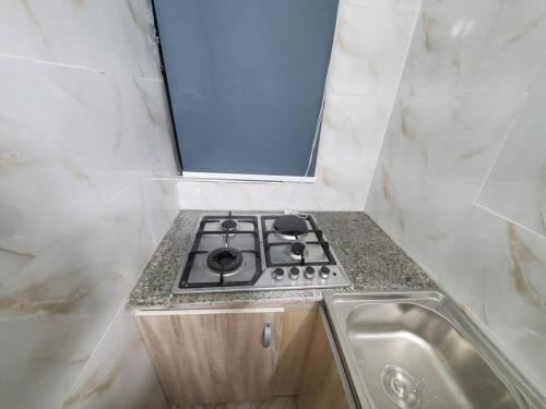 a stove in a bathroom with a sink at Spacious 2-bed Apt With 24hrs Power+ Unlimited Wi-Fi in Lagos