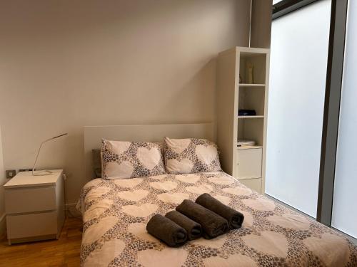 a bedroom with a bed with two towels on it at Fully Equipped Studio in Greenwich - 1 min to Station in London