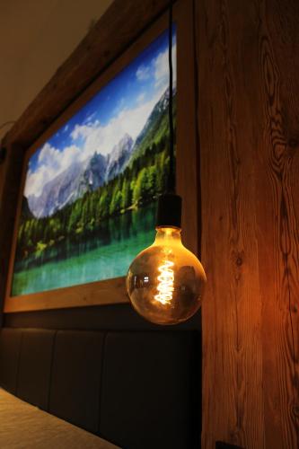 a television screen with a glass jar in front of a window at Gasthof & Hotel Bichler in Emmering