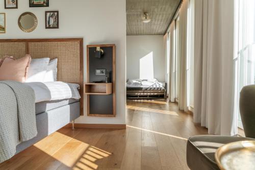 a bedroom with a bed and a mirror in a room at Fritiden Hotell & Kongress in Ystad