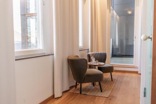 a room with two chairs and a table and a window at Fritiden Hotell & Kongress in Ystad