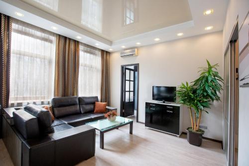 a living room with a couch and a tv at Apartment & Parking "Opera at the corner" in Odesa