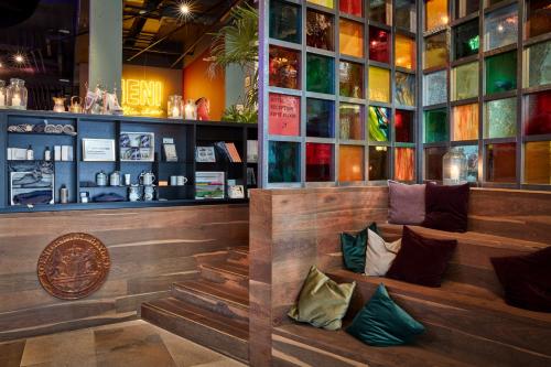 a restaurant with a bench with pillows on it at 25hours Hotel The Royal Bavarian in Munich