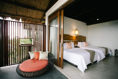 Säng eller sängar i ett rum på La Joya Farm Resort & Spa