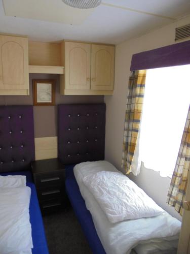 Ένα ή περισσότερα κρεβάτια σε δωμάτιο στο 6 Berth 3 bedroom panel heated on Kingfisher Florida