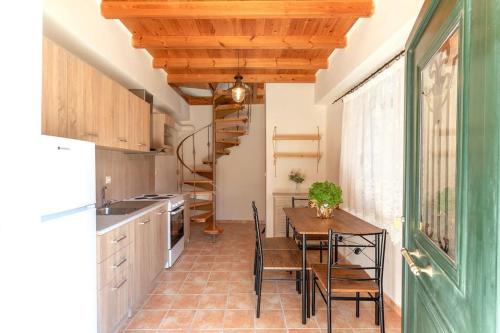 a kitchen with a table and chairs and a staircase at Elia Studio in Sokrakion