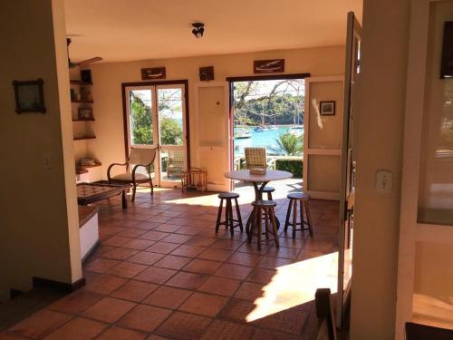 sala de estar con mesa y sillas y patio en Ossos Beach House en Búzios