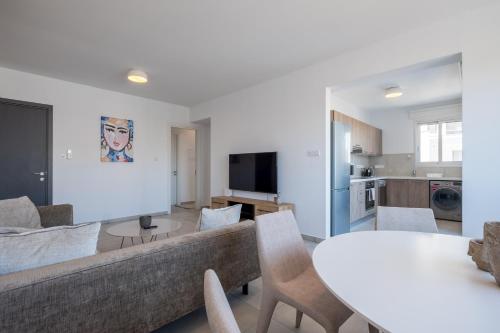 a living room with a couch and a table at Solaar Apartments Faneromeni in Larnaca