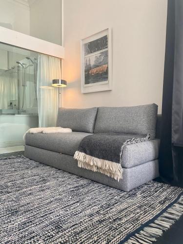 a couch in a living room with a rug at Museum Suites in Antwerp