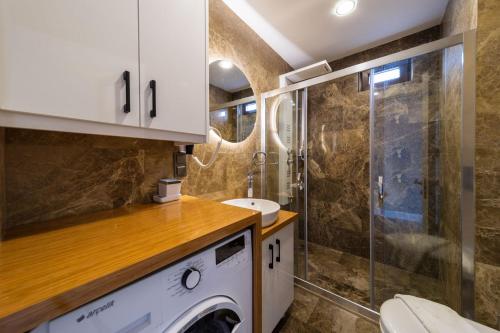a bathroom with a toilet and a sink and a shower at Sea View Flat with Hot Tub in Antalya Kas in Kas