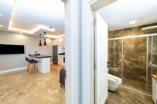 a bathroom with a shower and a toilet at Flat with Jacuzzi and Sea View in Kas Antalya in Kas