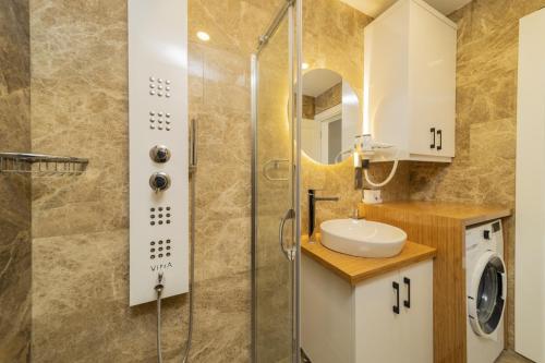a bathroom with a shower and a sink at Fully Furnished Flat with Sea View in Kas Antalya in Kas