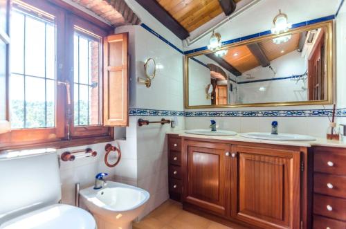 a bathroom with two sinks and a mirror at Club Villamar - Masia Can Vilar in Maçanet de la Selva