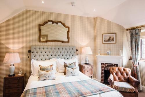 a bedroom with a large bed and a fireplace at Hever Castle Luxury Bed and Breakfast in Edenbridge