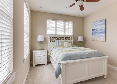 a bedroom with a bed and a ceiling fan at 406B The North End House in Virginia Beach