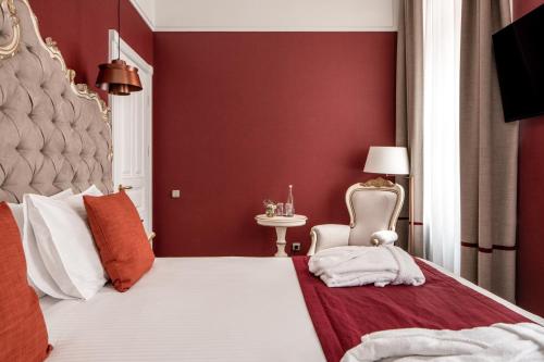 a bedroom with a bed with a red wall at Grand Hotel Lviv Casino & Spa in Lviv