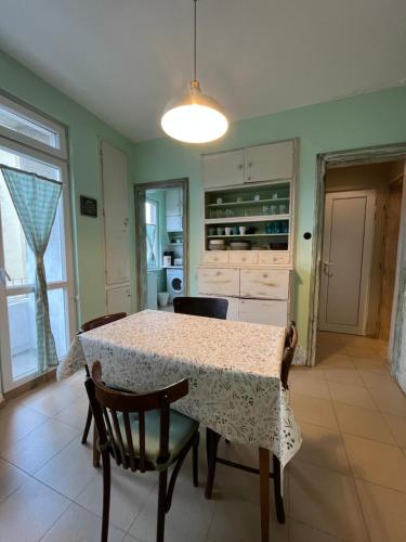 a dining room with a table and chairs and a kitchen at Your Space in Sofia in Sofia