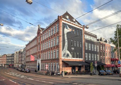 een groot bakstenen gebouw met een grote hond erop geschilderd bij Sir Albert Hotel, part of Sircle Collection in Amsterdam