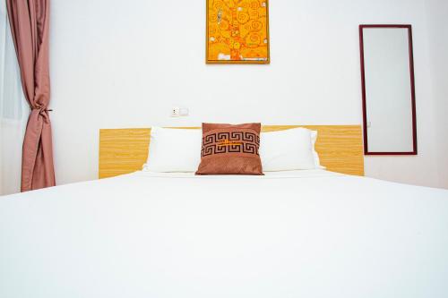 a bed with two pillows on top of it at Hôtel les Vallons in Abidjan