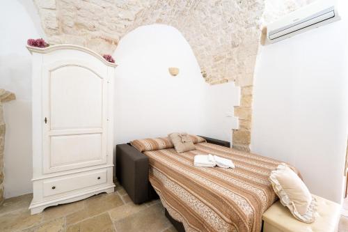 a bedroom with a bed in a white room at La Nicchia di Zio Valerio in Ceglie Messapica