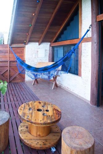 a hammock on the porch of a house at Pousada Alpes da Mantiqueira in Monte Verde