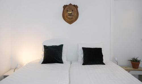 a bedroom with two beds and a lion head on the wall at Hotel Zilt Studio's in Vlissingen