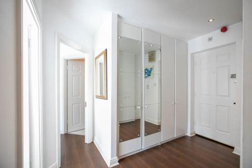 an empty room with white walls and a mirror at Grand Canal District Apartments in Dublin