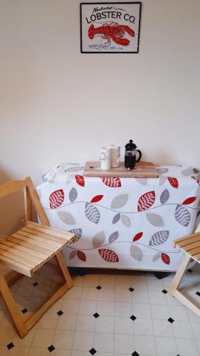 a bedroom with a bed and a table and chairs at Beauly Holiday Home in Beauly