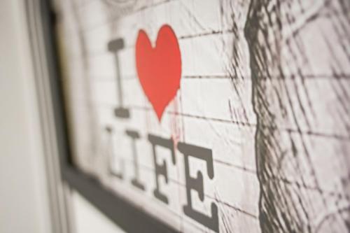 a sign with a red heart on a wall at Spacious Luxury Apartment in Stevenage, Sleeps 6, with Free Parking, and Free Wi-Fi in Stevenage