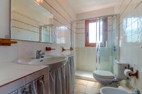 a bathroom with a sink and a toilet and a shower at Club Villamar - Andes in Lloret de Mar